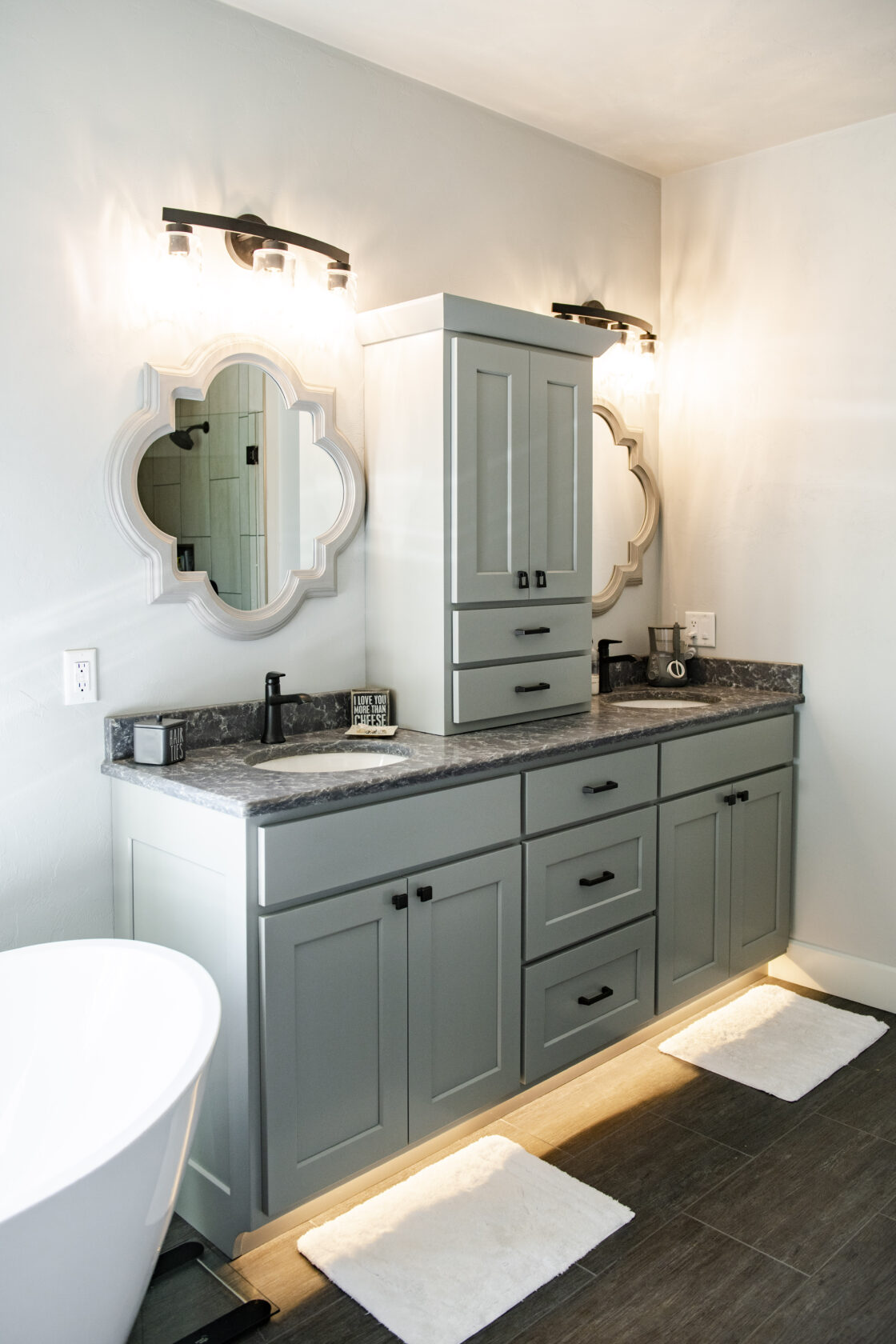 White custom cabinet bathroom vanity wth center tower and his and her sinks